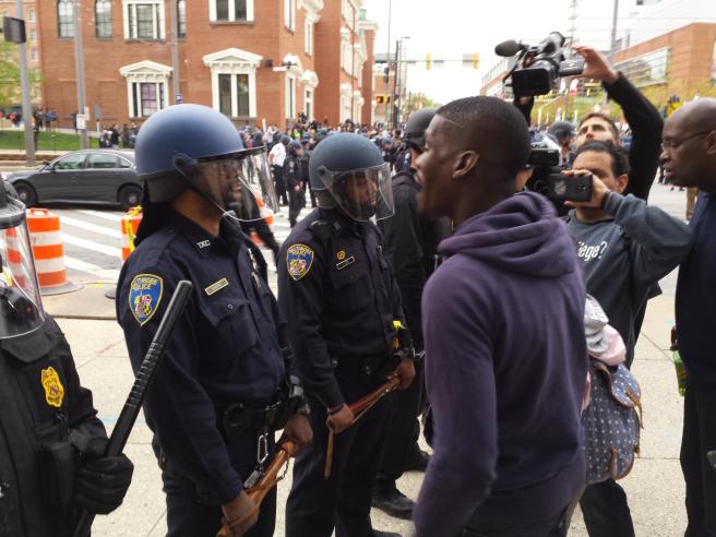 A protester screaming at a Baltimore Police officer after protests in the wake of Freddie Gray's death. This moment - from April 25, 2015 - was after protesters and police clashed near Camden Yards.